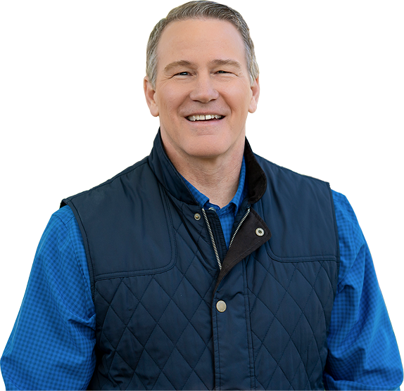 Jon Husted smiling in a blue vest